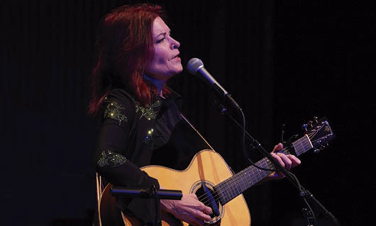 Rosanne Cash singing and playing guitar on stage at SFJAZZ