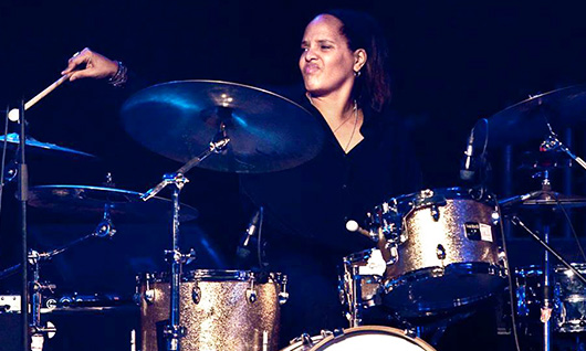 Terri Lyne Carrington performing behind the drum kit