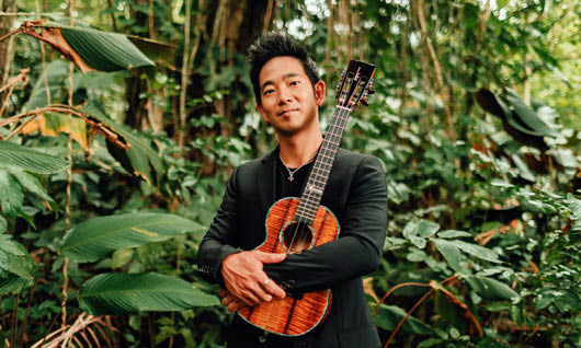 JAKE SHIMABUKURO holding a small guitar